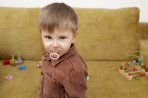 medium shot cute kid with pacifier